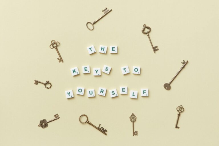 Motivational message with antique keys and letter blocks on yellow background.